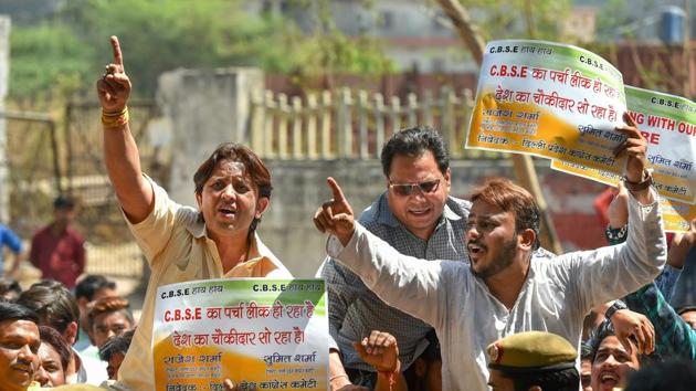 Congress workers hold placards and protest against Board exam paper leak outside CBSE headquarters in New Delhi on Friday.(PTI Photo)