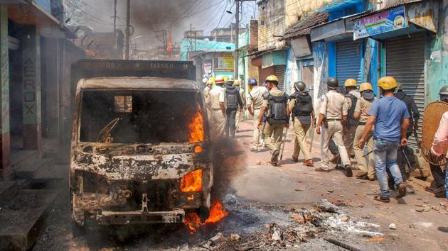 Police personnel patrol after clashes and incidents of arson over Ram Navami procession at Raniganj in Burdwan district, West Bengal. (PTI) Police personnel patrol after clashes and incidents of arson over Ram Navami procession at Raniganj in Burdwan district, West Bengal. (PTI)