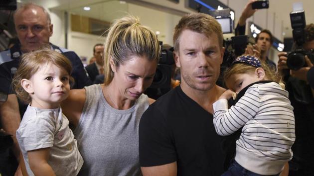 Warner, second right, arrives with his wife Candice, second left, and their children at Sydney Airport, Thursday after being sent home from South Africa. (AP)
