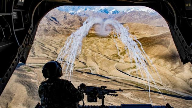 A US Army crew chief flying on board a CH-47F Chinook helicopter observes the successful test of flares during a training flight in Afghanistan. (Tech. Sgt. Gregory Brook / U.S. Air Force / REUTERS)
