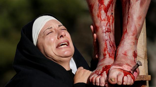 An actor, portraying Mary, takes part in the interactive street-theatre Passion play in the run-up to Easter, in the grounds of Mount Carmel Mental Hospital in Attard, Malta. (Darrin Zammit Lupi / REUTERS)