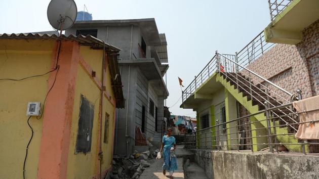 A woman walks through an alley in a village on Elephanta Island. “It’s been 70 years since India’s independence and we’ve been promised electricity for so long. I’m just glad to see it before I die,” said 69-year-old Bhagwan Tali. (Punit Paranjpe / AFP) A woman walks through an alley in a village on Elephanta Island. “It’s been 70 years since India’s independence and we’ve been promised electricity for so long. I’m just glad to see it before I die,” said 69-year-old Bhagwan Tali. (Punit Paranjpe / AFP)