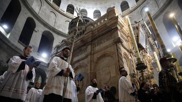 Catholic clergy circle the Edicule at the Church of the Holy Sepulchre, traditionally believed to be the site of the crucifixion and burial of Jesus Christ, in Jerusalem. (Mahmoud Illean / AP) Catholic clergy circle the Edicule at the Church of the Holy Sepulchre, traditionally believed to be the site of the crucifixion and burial of Jesus Christ, in Jerusalem. (Mahmoud Illean / AP)