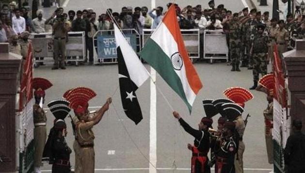 Pakistani rangers (wearing black uniforms) and Indian Border Security Force (BSF) officers lower their national flags during a daily parade at the Pakistan-India joint checkpost at Wagah border on November 3, 2014.(Reuters)