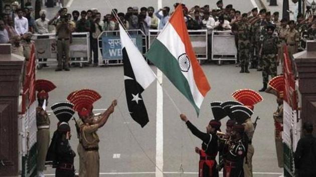 Pakistani rangers (wearing black uniforms) and Indian Border Security Force (BSF) officers lower their national flags during a daily parade at the Pakistan-India joint check-post at Wagah border, near Lahore November 3, 2014.(Reuters File Photo)