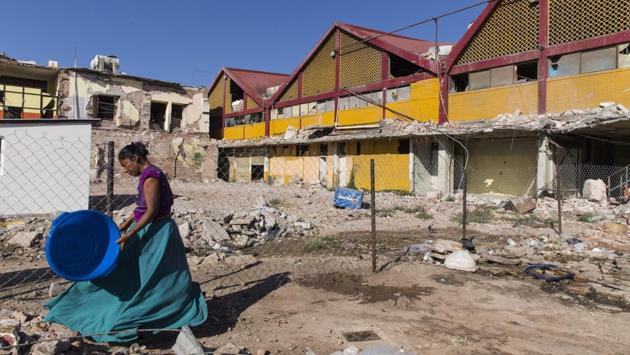 A resident passes in front of a market destroyed in the September earthquake in Juchitan, Oaxaca State, Mexico. “At a time when people felt so insecure and scared, they were so happy to have some form of light,” Guerra said. “It gave me so much satisfaction to be able to provide it.” (Yael Martinez / Bloomberg)
