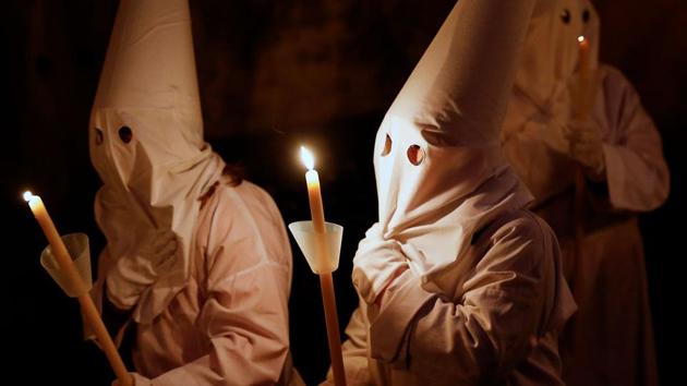 Penitents take part in a Holy Week procession in Verges, northeastern Spain. Christian believers around the world mark the Holy Week of Easter in celebration of the crucifixion and resurrection of Jesus Christ. (Pau Barrena / AFP) Penitents take part in a Holy Week procession in Verges, northeastern Spain. Christian believers around the world mark the Holy Week of Easter in celebration of the crucifixion and resurrection of Jesus Christ. (Pau Barrena / AFP)