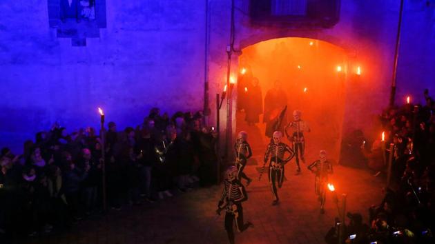 Dancers in body stockings with skeletons painted on them and carrying symbols to stir people to prepare for a good death perform the Dance of the Death during a Holy Week procession in Verges, Spain. (Pau Barrena / AFP) Dancers in body stockings with skeletons painted on them and carrying symbols to stir people to prepare for a good death perform the Dance of the Death during a Holy Week procession in Verges, Spain. (Pau Barrena / AFP)