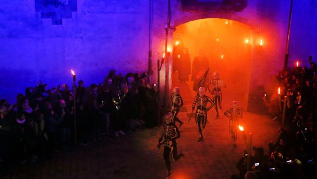 Dancers in bodysuits with skeletons painted on them, perform the Dance of the Death during a Holy Week procession in Verges, northeastern Spain. (Pau Barrena / AFP)