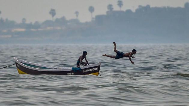 A boy looks on as his friend dives into the Arabian Sea, on a hot day in Mumbai, Maharashtra. (Mitesh Bhuvad / PTI) A boy looks on as his friend dives into the Arabian Sea, on a hot day in Mumbai, Maharashtra. (Mitesh Bhuvad / PTI)