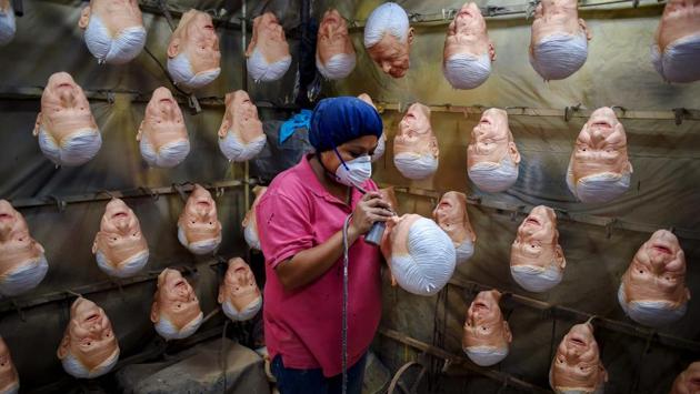 An employee gives finishing touches to a latex mask of Mexican presidential candidate Andres Manuel Lopez Obrador, of the MORENA party, at Rev, a factory in Cuernavaca, Morelos State, Mexico as the country prepares for general elections on July 1. (Alfredo Estrella / AFP)