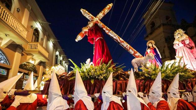 Catholic faithful carry the image of the “Jesus of the Great Power” during a procession on Holy Week, at La Merced church in Granada, Spain. (Inti Ocon / AFP) Catholic faithful carry the image of the “Jesus of the Great Power” during a procession on Holy Week, at La Merced church in Granada, Spain. (Inti Ocon / AFP)