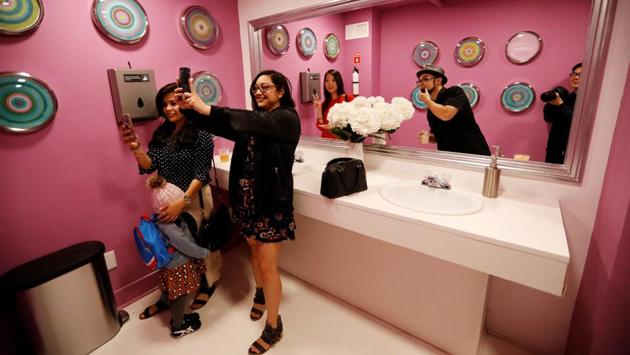 Guests take pictures in the “bathroom selfie,” a two-sided room that lacks self-reflection. (Mario Anzuoni / REUTERS) Guests take pictures in the “bathroom selfie,” a two-sided room that lacks self-reflection. (Mario Anzuoni / REUTERS)