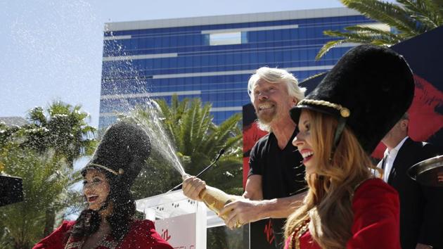 Virgin Group founder Richard Branson sprays champagne at a news conference Friday, March 30, 2018, in Las Vegas where Virgin Hotels announced that it had bought the Hard Rock hotel and casino in Las Vegas. (AP Photo) Virgin Group founder Richard Branson sprays champagne at a news conference Friday, March 30, 2018, in Las Vegas where Virgin Hotels announced that it had bought the Hard Rock hotel and casino in Las Vegas. (AP Photo)