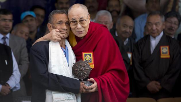 Tibetan spiritual leader the Dalai Lama felicitates Naren Chandra Das, a soldier who was part of the group that received the leader at the border in 1959, at an event marking the beginning of the 60th year of the spiritual leader's exile in India, in Dharmsalaon Saturday. (AP) Tibetan spiritual leader the Dalai Lama felicitates Naren Chandra Das, a soldier who was part of the group that received the leader at the border in 1959, at an event marking the beginning of the 60th year of the spiritual leader's exile in India, in Dharmsalaon Saturday. (AP)