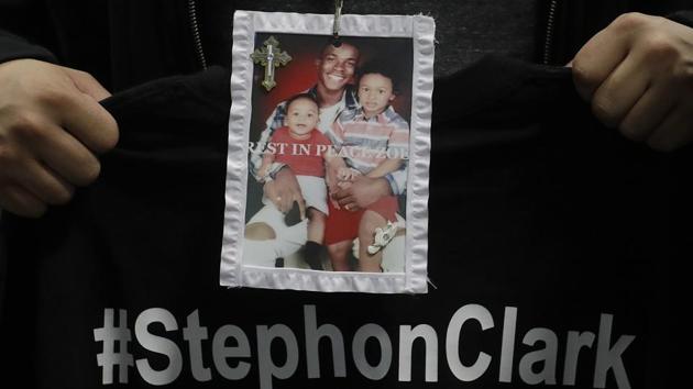 A mourner holds up a photo of police shooting victim Stephon Clark during the funeral services for Clark in Sacramento, California on March 29, 2018. Clark, who was unarmed, was shot and killed by Sacramento Police Officers, on March 18. (AP) A mourner holds up a photo of police shooting victim Stephon Clark during the funeral services for Clark in Sacramento, California on March 29, 2018. Clark, who was unarmed, was shot and killed by Sacramento Police Officers, on March 18. (AP)