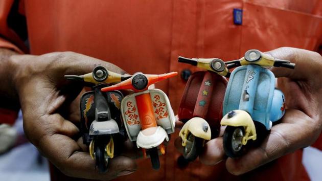 A shopkeeper and Vespa enthusiast holds his collection of memorabilia, at his auto parts shop in Karachi. Nagra said Vespas were the second best gift Italy gave to the world - “the first being pizza” - as he recalled driving from Lahore to the Chinese border crossing at the Khunjerab Pass, some 15,397 feet above sea level in the Karakoram mountains. (Akhtar Soomro / REUTERS) A shopkeeper and Vespa enthusiast holds his collection of memorabilia, at his auto parts shop in Karachi. Nagra said Vespas were the second best gift Italy gave to the world - “the first being pizza” - as he recalled driving from Lahore to the Chinese border crossing at the Khunjerab Pass, some 15,397 feet above sea level in the Karakoram mountains. (Akhtar Soomro / REUTERS)