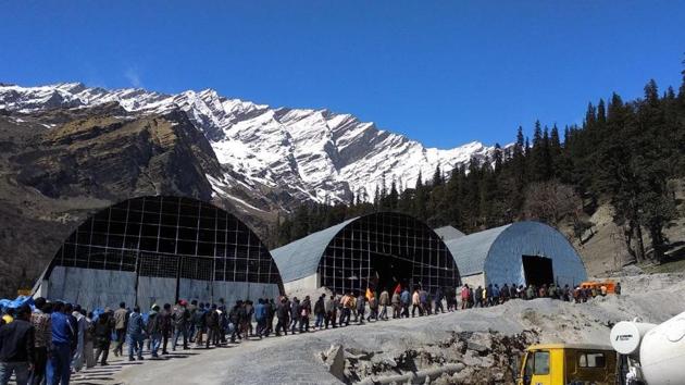 The protesting workers near the tunnel’s south portal in Dhundhi, Kullu, on Sunday.(HT Photo)