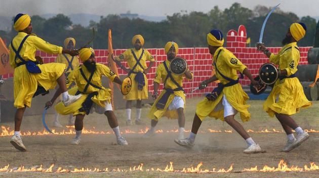 Army personnel perform Gatka, a martial art form of Punjab, during the 124th Raising Day of Southern Command Military Tattoo event at Race course in Pune on March 31. (PRATHAM GOKHALE/HT PHOTO)