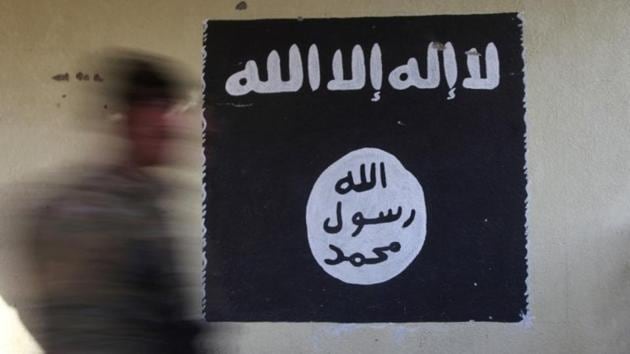 A member of the Iraqi rapid response forces walks past a wall painted with the black flag commonly used by Islamic State militants, in the Wahda district of eastern Mosul, Iraq on January 8, 2017.(Reuters/Representative image)