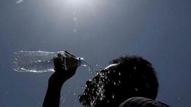 A man pours water on his face during a hot summer day in Hyderabad.(AP File Photo)