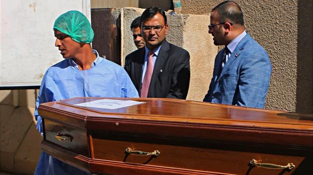 Pradeep Singh Rajpurohit, center, India's Ambassador to Iraq, watches while a casket holding one of Indians abducted by the Islamic State group in 2014, is loaded on a truck to be transported from Baghdad's main morgue to the Baghdad airport, in Iraq on April 1.(AP Photo)