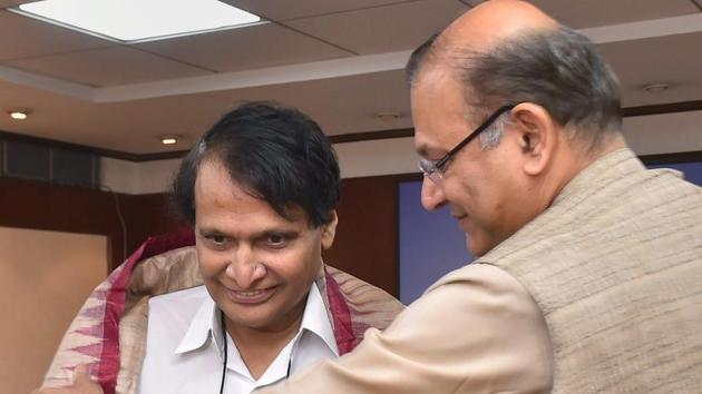 New civil aviation minister Suresh Prabhu being welcomed by MoS Jayant Sinha at his office at Rajiv Bhawan in New Delhi.(PTI Photo) New civil aviation minister Suresh Prabhu being welcomed by MoS Jayant Sinha at his office at Rajiv Bhawan in New Delhi.(PTI Photo)