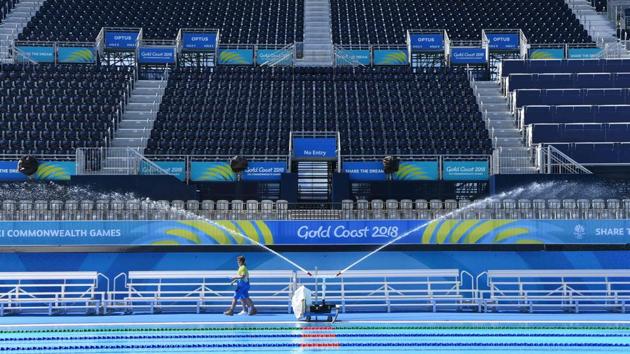 Volunteers walk past pumps which are used to cool the swimming pool water at the Optus Aquatic Centre (GAC), ahead of the start of the event. (AFP)