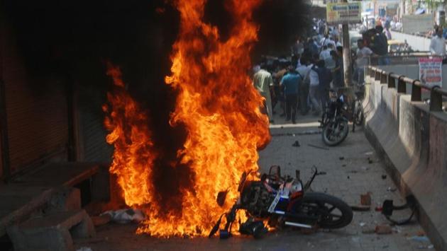 A police motorcycle is seen aflame during a protest in Ghaziabad. In Meerut, protesters torched Shobhapur police post and vandalised a car and motorcycle. As protests turn violent, two companies of RAF in Meerut and one company in Hapur were being deputed. (SAkib Ali / HT Photo)