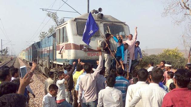 Protesters stop a train at Ghatla railway station in Alwar district on Monday .(HT Photo) Protesters stop a train at Ghatla railway station in Alwar district on Monday .(HT Photo)