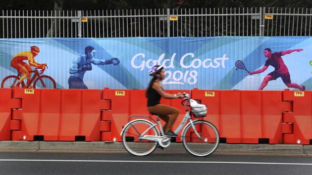 A cyclist rides past Commonwealth Games banner on the side of the road in Gold Coast. (AP) A cyclist rides past Commonwealth Games banner on the side of the road in Gold Coast. (AP)