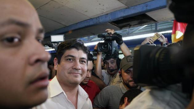 Presidential candidate Carlos Alvarado, with National Restoration Party, walks away after casting his vote in a presidential runoff election in San Jose, Costa Rica, Sunday, April 1, 2018.(AP Photo)