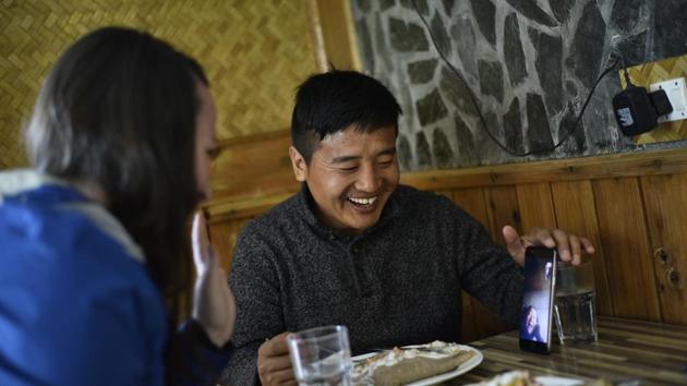 For Tsultrim, 30, home might now be the US, where he plans to move and settle with his partner Molly Laurie, an American journalist based in McLeodganj. This doesn’t come without its pangs of anxiety. Tsultrim has been craving to go back to Tibet to see his ailing mother but his visa requests have been rejected eight times by Chinese authorities. Here seen chatting with his mother on the phone back home. (Anushree Fadnavis / HT Photo) For Tsultrim, 30, home might now be the US, where he plans to move and settle with his partner Molly Laurie, an American journalist based in McLeodganj. This doesn’t come without its pangs of anxiety. Tsultrim has been craving to go back to Tibet to see his ailing mother but his visa requests have been rejected eight times by Chinese authorities. Here seen chatting with his mother on the phone back home. (Anushree Fadnavis / HT Photo)