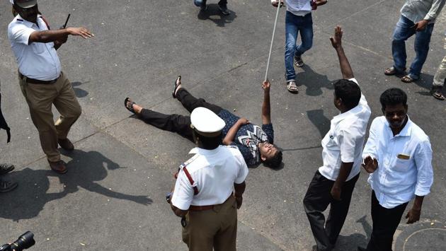 Two DMK workers on Monday allegedly attempted self immolation while protesting in Coimbatore against the Centre for its ‘failure’ to constitute the CMB in compliance with the February 16 order of the Supreme Court, police said. However, they were over powered by a few police personnel present at the spot and whisked away to a nearby police station. (R Senthil Kumar / PTI) Two DMK workers on Monday allegedly attempted self immolation while protesting in Coimbatore against the Centre for its ‘failure’ to constitute the CMB in compliance with the February 16 order of the Supreme Court, police said. However, they were over powered by a few police personnel present at the spot and whisked away to a nearby police station. (R Senthil Kumar / PTI)