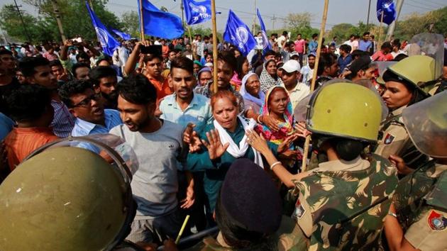 Police try to stop people belonging to the Dalit community as they take part in a protest during a nationwide strike called by Dalit organisations, in Chandigarh, April 2.(Reuters Photo)