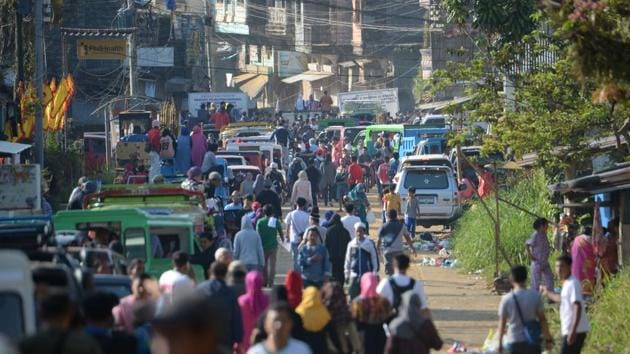 Thousands of residents wait to pass through a military check point to visit their destroyed houses at the main battle area in Marawi City. Over the course of the next month other groups of residents will be allowed to return for up to three days each, to view their old homes and salvage what they can before rebuilding starts. (Ted Aljibe / AFP)