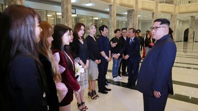 Kim, wearing a dark Mao-style suit, made a surprise visit to the performance with his wife Ri Sol Ju, sister Kim Yo Jong and other senior North Korean officials, including nominal head of state Kim Yong Nam. The North Korean leader applauded during the event and also met the South Korean performers. (KCNA via REUTERS) 