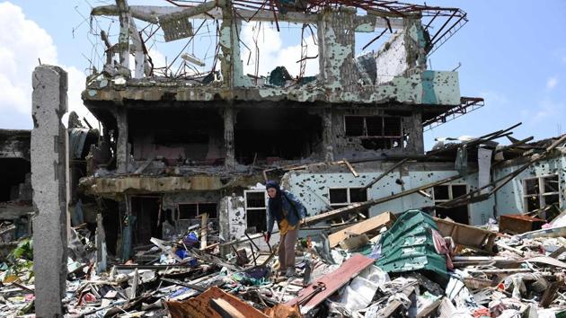 After fleeing for their lives nearly a year ago, some residents of the ravaged Philippine city of Marawi were allowed back Sunday for the first time -- to dig through rubble they once called homes. Swathes of the southern city were destroyed in five months of house-to-house fighting between troops and jihadists loyal to the Islamic State group that killed nearly 1,200. (Ted Aljibe / AFP)