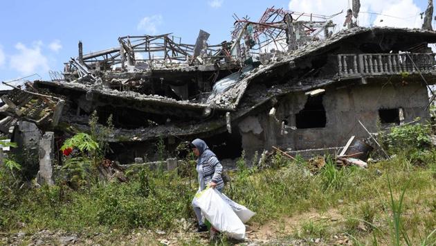 The threat posed by those bombs as well as memories of their flight, were uppermost in the minds of Sunday’s visitors. “We left because we thought the soldiers were about to respond and there would be a gunfight,” said Mangcol, the bridal shop owner, of her escape. “A bullet does not recognise a civilian from a terrorist.” (Ted Aljibe / AFP)