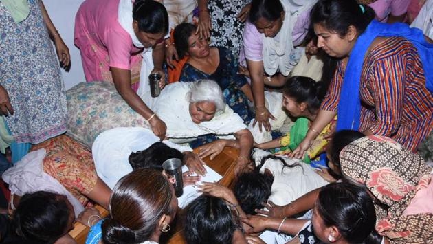 Family members and relatives of Balwant Rai, grieve by his coffin at his native village on the outskirts of Jalandhar, Punjab. Minister of state for external affairs VK Singh on Monday brought the mortal remains of 38 of the 39 Indians and visited Amritsar to hand over remains of 27 workers from Punjab. (Pardeep Pandit / HT Photo)