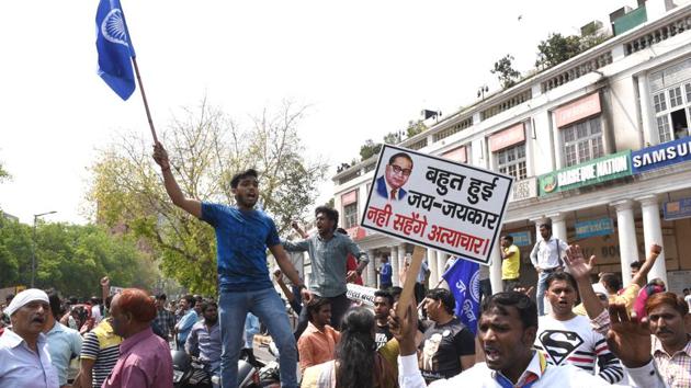 Members of the Dalit community stage a protest during ‘Bharat Bandh’ against Supreme Court judgement at Connaught place in New Delhi on Monday. The Supreme Court on Tuesday refused to stay its order on Scheduled Castes and the Scheduled Tribes (Prevention of Atrocities) Act, 1989. The top court asked all parties to submit detailed report within two days and the matter will be heard after 10 days. (Arvind Yadav / HT File)