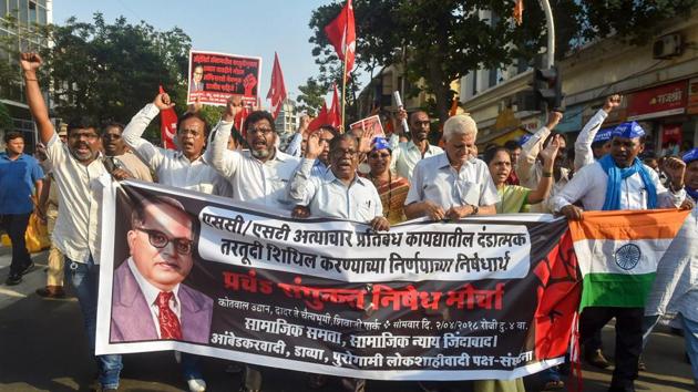 Dalit activist and supporters hold placards and raise slogans during a protest march against the alleged dilution of Scheduled Castes/Scheduled Tribes Act in Mumbai on Monday.(PTI photo) Dalit activist and supporters hold placards and raise slogans during a protest march against the alleged dilution of Scheduled Castes/Scheduled Tribes Act in Mumbai on Monday.(PTI photo)