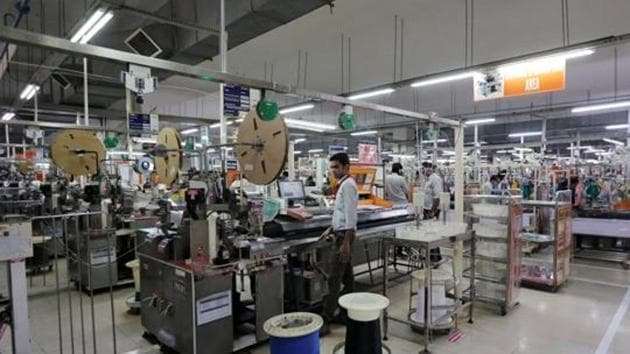 Employees of Motherson Sumi Systems Ltd, work on a car wiring assembly line inside a factory in Noida on the outskirts of New Delhi.(REUTERS File Photo)