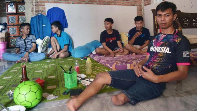 When Eman Sulaeman (R) begged his parents as a child to let him play football, the couple worried their son -- born with no feet and just one full leg -- would be mocked. “I cried for days, begging them to buy me a ball,” he said, in the small town of Indramayu, 220 kilometres east of Jakarta. “They relented and went out to find me a cheap plastic ball.” (Adek Berry / AFP)