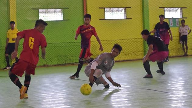 Eman Sulaeman (C) attempts possession of the ball during a futsal match. His talents have caught the attention of West Java’s sports agency, lifting hopes that the government might boost its support for disabled athletes. (Adek Berry / AFP)