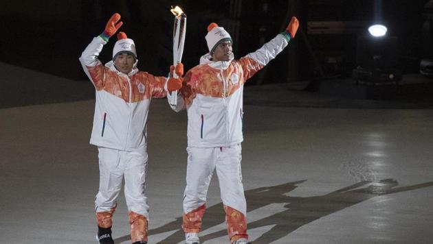 North and South Korea athletes, from left, Choi Bogue and MA Yu Chol wave during the opening ceremony for the XII Paralympic Winter Games in the Pyeongchang Olympic Stadium in South Korea, March 9, 2018.(AP)