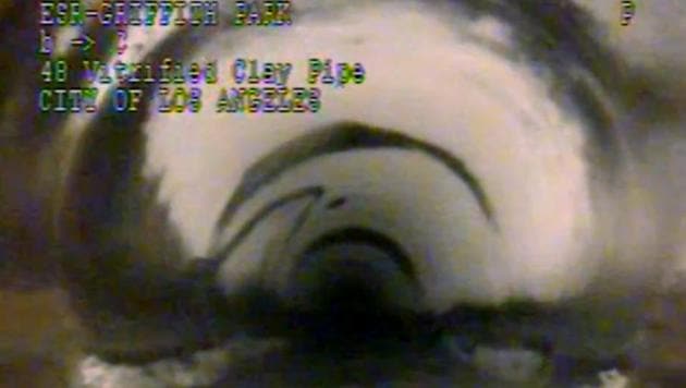 This photo from remote camera video provided by the Los Angeles Department of Sanitation shows where 13-year-old Jesse Hernandez traced an arc with his fingers, the small arc at center left, as he was swept through a 4-foot diameter pipe after falling into a hole in Griffith Park in Los Angeles Monday, April 2, 2018.(AP Photo) This photo from remote camera video provided by the Los Angeles Department of Sanitation shows where 13-year-old Jesse Hernandez traced an arc with his fingers, the small arc at center left, as he was swept through a 4-foot diameter pipe after falling into a hole in Griffith Park in Los Angeles Monday, April 2, 2018.(AP Photo)