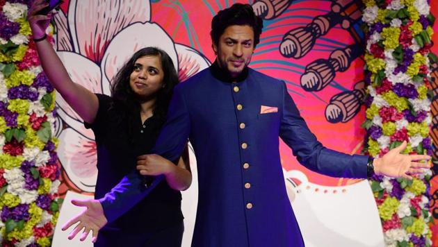 A visitor takes a selfie with a waxwork of Bollywood actor Shah Rukh Khan after it was unveiled at Madame Tussauds Delhi. (AFP) A visitor takes a selfie with a waxwork of Bollywood actor Shah Rukh Khan after it was unveiled at Madame Tussauds Delhi. (AFP)