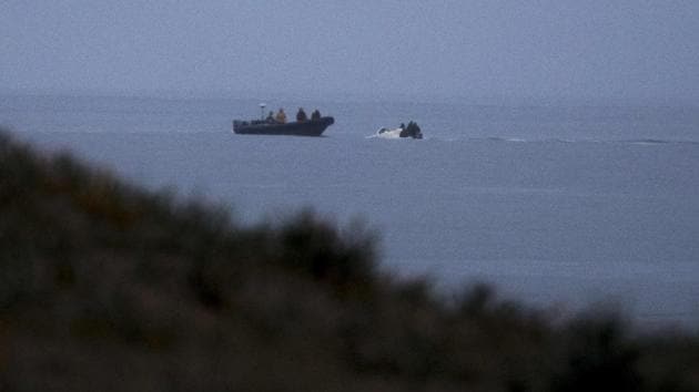 For now the boats arrive, and when one does, spotters rush to unload the craft as passers-by look on. Only word that a police car is approaching brings an abrupt end to operations. “You see, this is like a game of cat and mouse, but you won’t see the guns, at least not on our side,” a top associate of Los Castanitas said. “Yes, this is illegal... But we are not hurting anyone.” (Emilio Morenatti / AP) For now the boats arrive, and when one does, spotters rush to unload the craft as passers-by look on. Only word that a police car is approaching brings an abrupt end to operations. “You see, this is like a game of cat and mouse, but you won’t see the guns, at least not on our side,” a top associate of Los Castanitas said. “Yes, this is illegal... But we are not hurting anyone.” (Emilio Morenatti / AP)