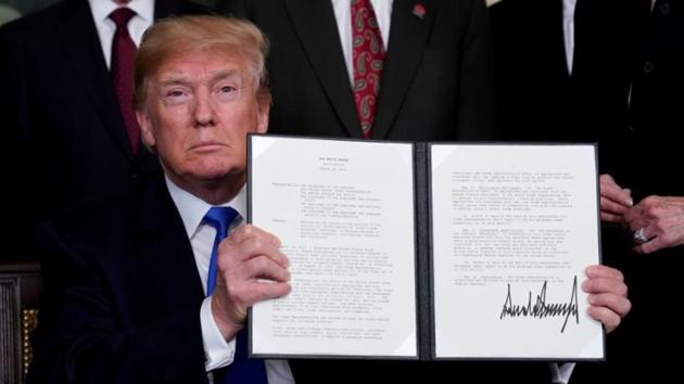 US President Donald Trump holds his signed memorandum on intellectual property tariffs on high-tech goods from China, at the White House in Washington on March 22, 2018. (Reuters File Photo) US President Donald Trump holds his signed memorandum on intellectual property tariffs on high-tech goods from China, at the White House in Washington on March 22, 2018. (Reuters File Photo)